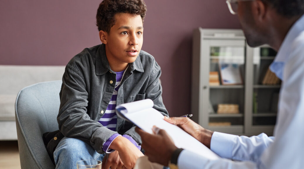 teenage boy sharing his thoughts on anxiety with adolescent psychologist