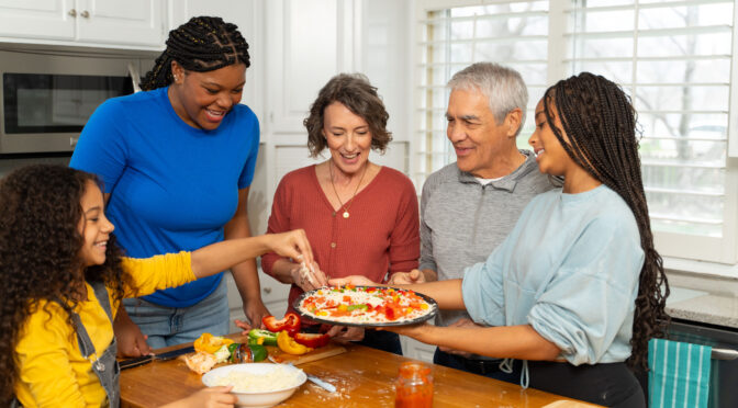 Family preparing homemade pizza